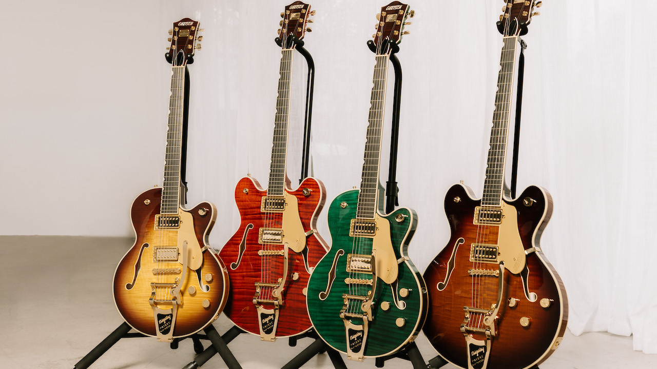 Four Gretsch Broadkaster LX Figured Center Block guitars with String-Thru Bigsby vibrato tailpieces displayed on stands in Havana Burst, Bourbon Stain, Caramel Dawn, and Tropic Aura finishes.