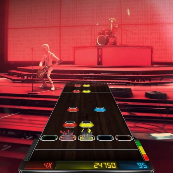 Gameplay screenshot of Stage Tour showing a band performing on stage with a guitar rhythm track interface in the foreground.